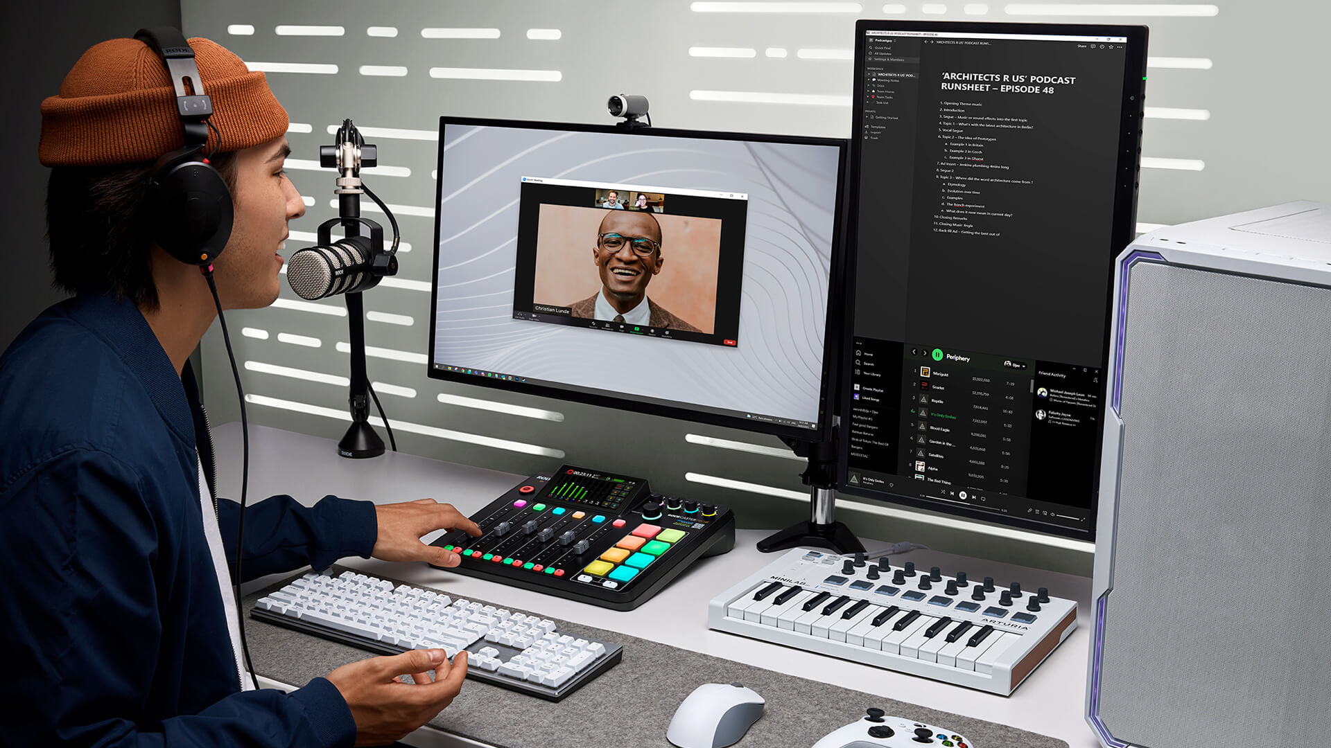 Man wearing NTH-100 and talking into PodMic whilst using RØDECaster Pro II for video call