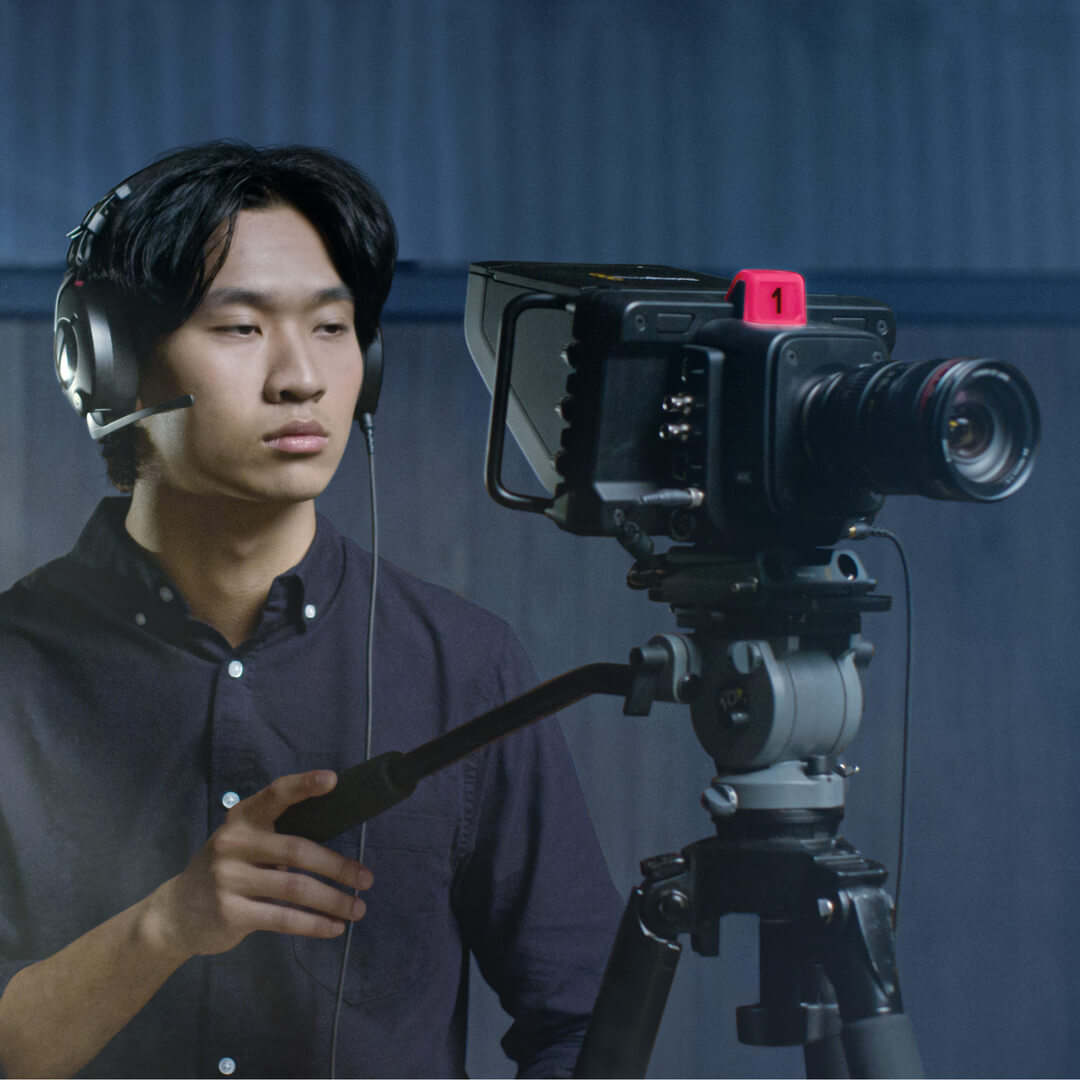 Man wearing NTH-100M and operating camera