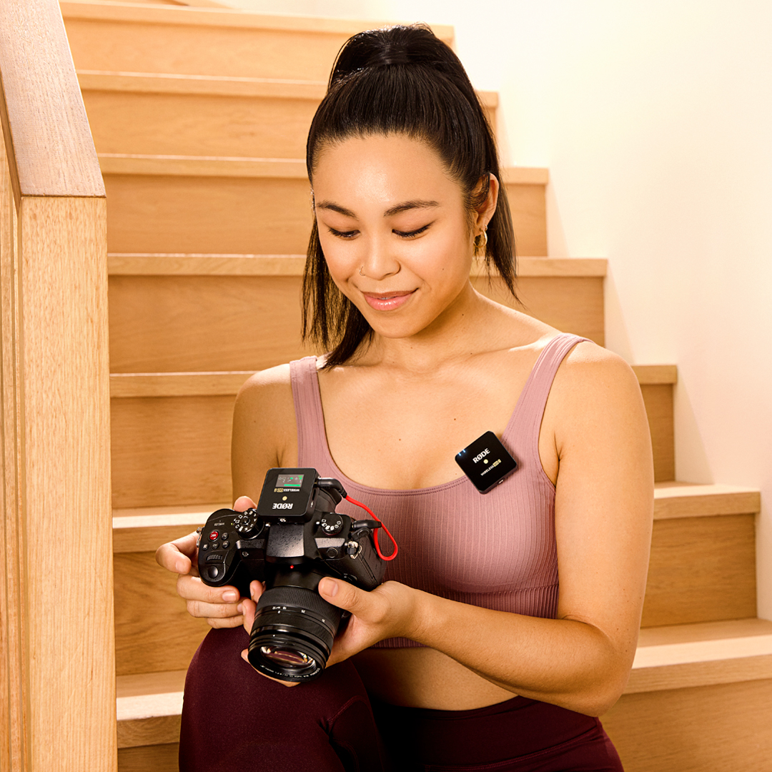 Girl on staircase with Wireless GO II Single on camera and top