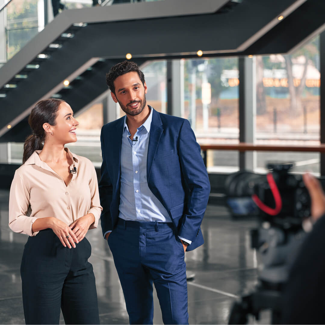 Couple in front of camera mounted on tripod with Wireless GO II connected